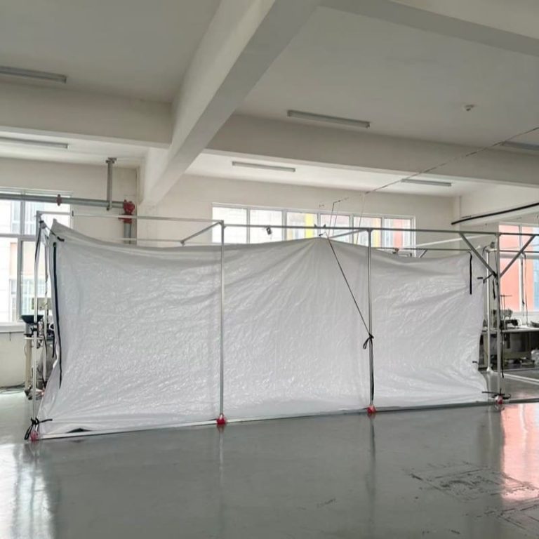 White container liner side panel suspended on a factory frame